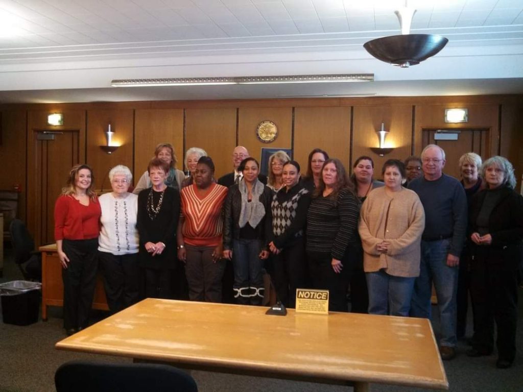 History group of CASA volunteers standing in courtroom